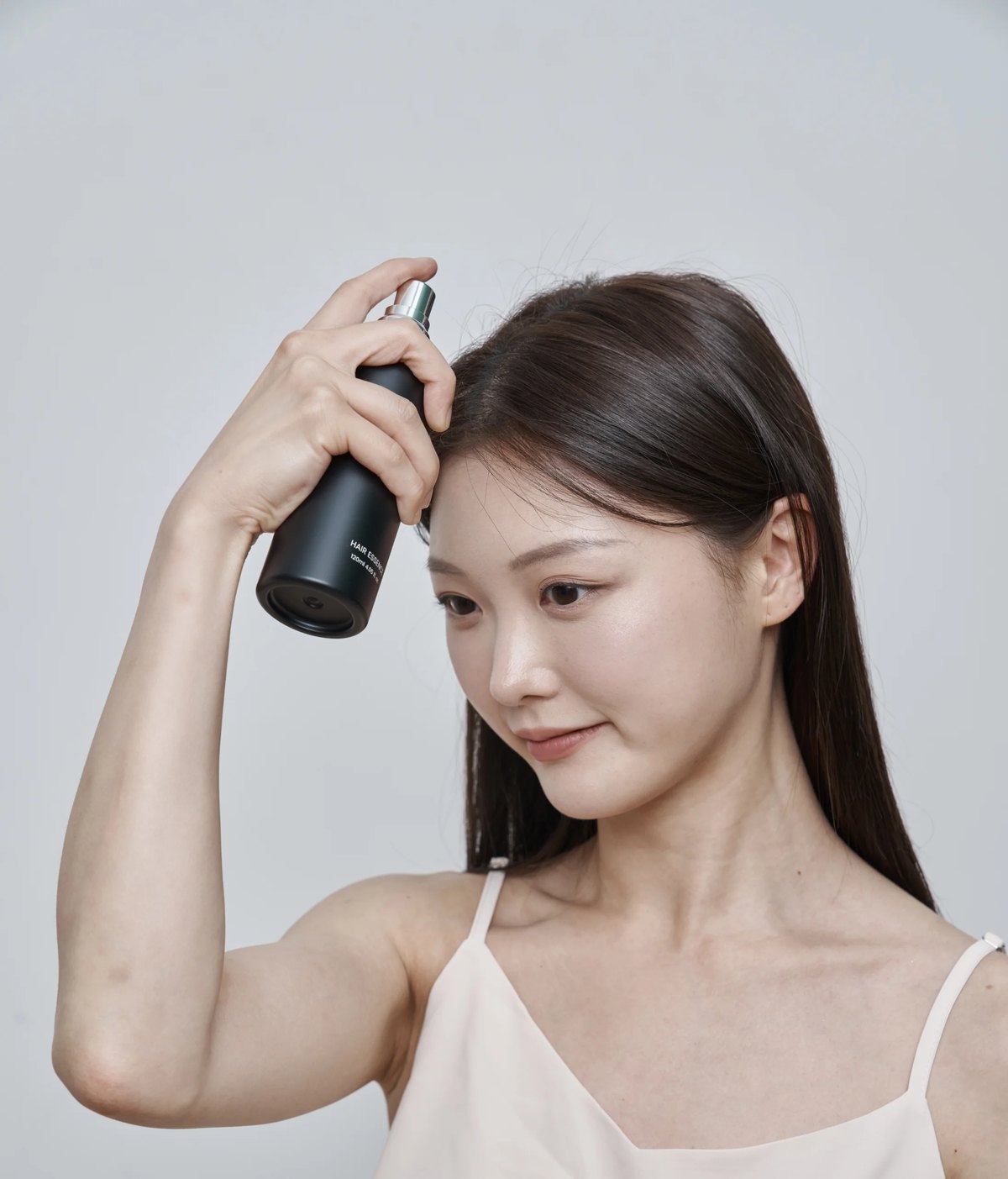 탈모증상완화토닉을 두피에 뿌리는 여성의 옆모습